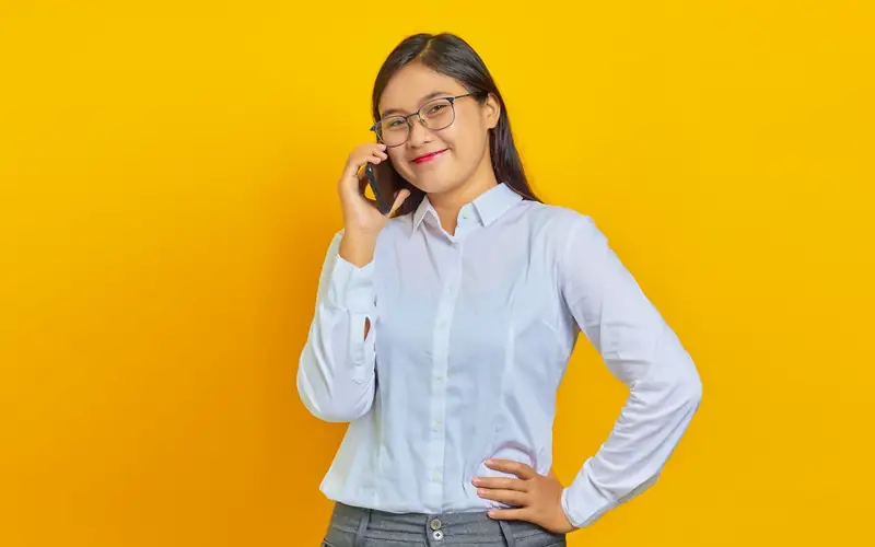 Young Filipina woman in glasses on a phone call, checking an EM777PH GCash deposit with support