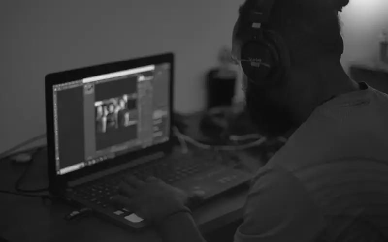 Player wearing a headset using a laptop, showing EM777PH played on a desktop browser